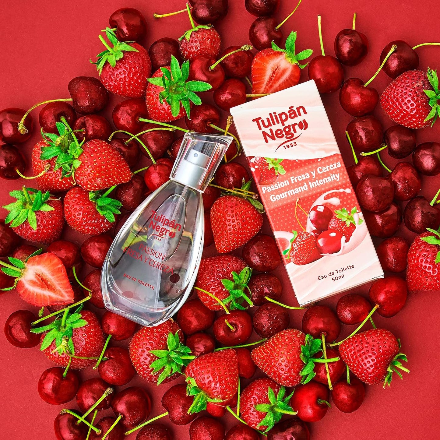 Tulipan Negro - água de colónia unissexo, morango e cereja, 50 ml em embalagem ao lado de morangos e cerejas